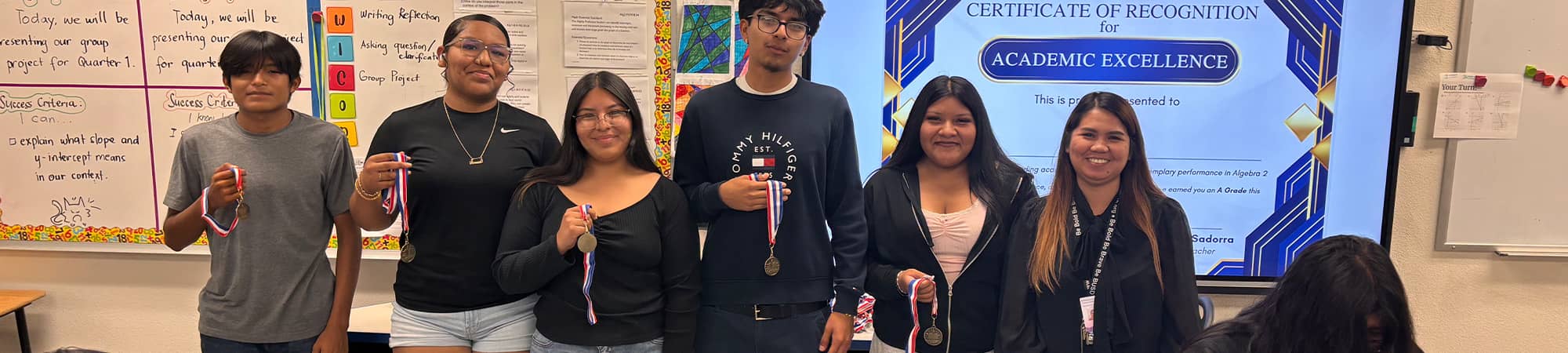 Students holding medals