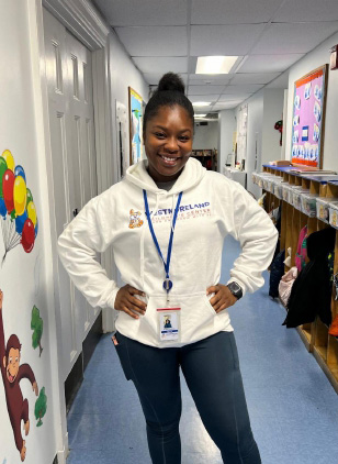 Angie Kamara wearing a WCC hooded sweatshirt