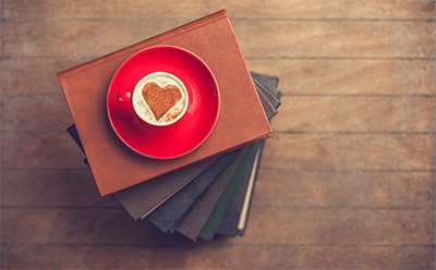 Books with a cute cup of coffee on top