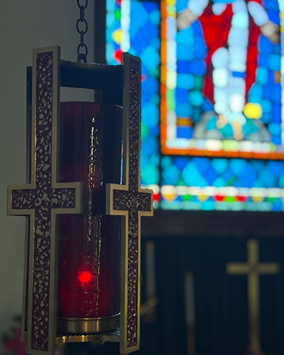 a hanging lantern with crosses around it