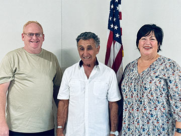 Three staff members smiling