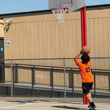 Boy shooting a basketball at a hoop Boy shooting a basketball at a hoop