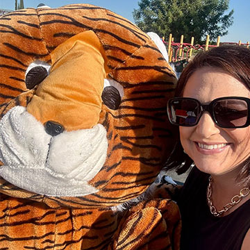 Staff member selfie with the tiger mascot Staff member selfie with the tiger mascot