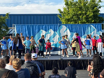 Students performing a play on stage Students performing a play on stage