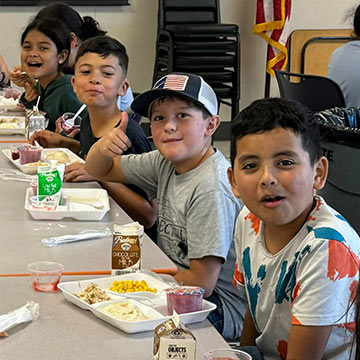 Students sitting and eating lunch in the cafeteria Students sitting and eating lunch in the cafeteria