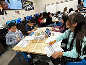 Students working on a science project in class Students working on a science project in class