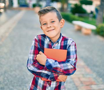 Student holding a folder smiling