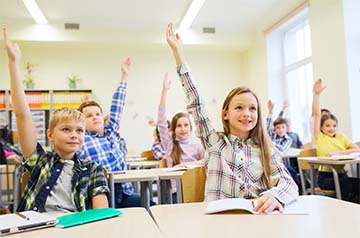 students raising their hands