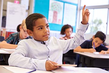 student raising hand in class