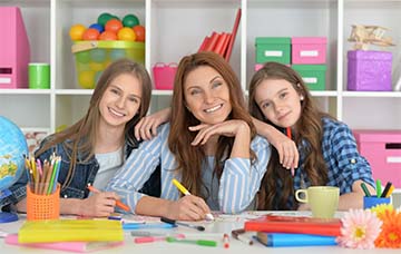 Teacher smiling with two students