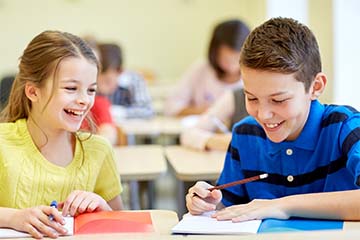 two students laughing and working together