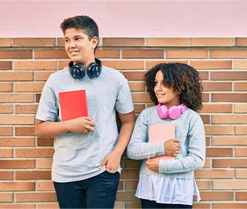 students standing against a brick wall