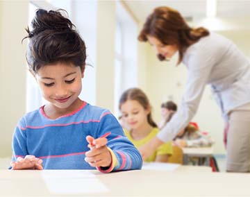 Student writing on paper