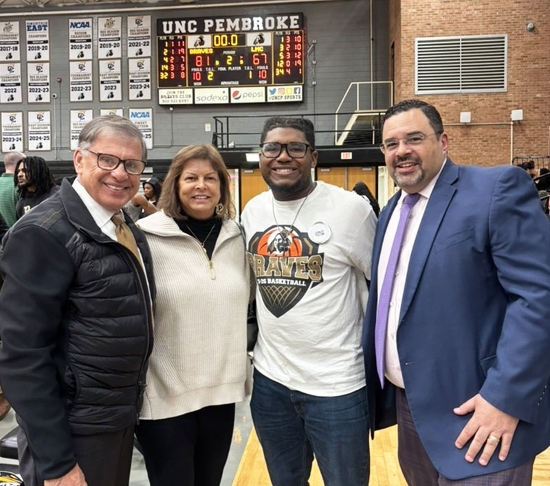 Elijah in the UNC Pembroke gym with three other adults