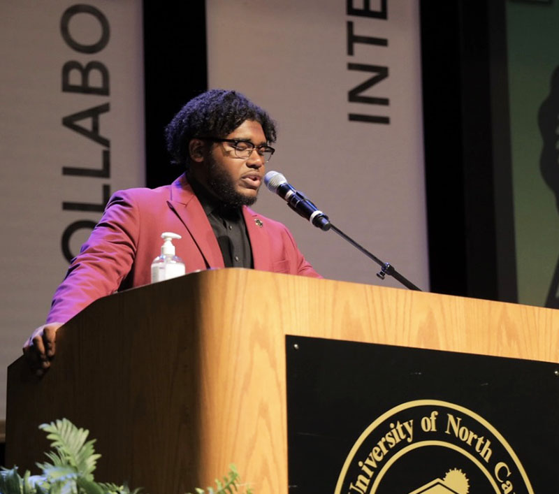 Elijah Griffin speaking at a UNC Pembroke podium