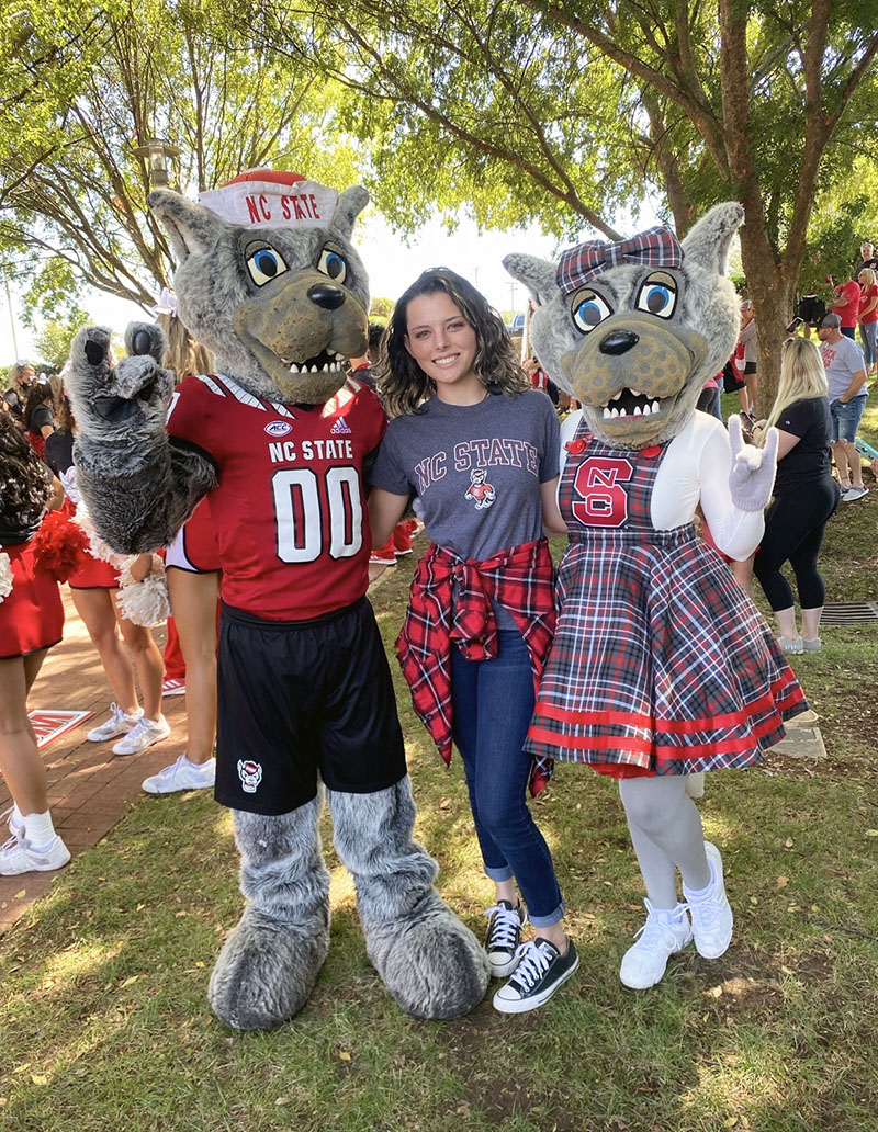 Sophia Metcalf with two NC State mascots outside