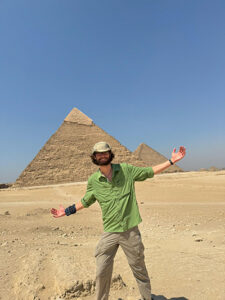Isaac Watkins in front of Egyptian pyramids