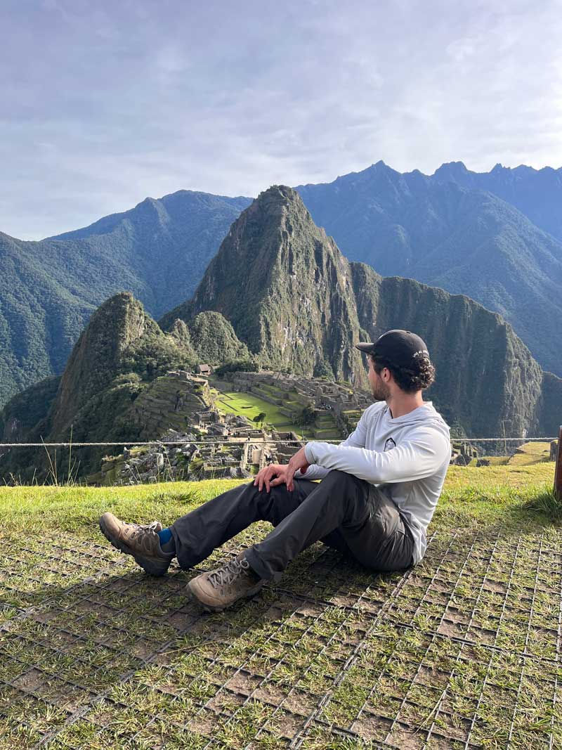 Alex taking a break and looking at a valley in the mountain next to him