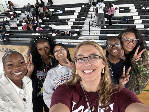 Layla Brewer taking a selfie with a group of friends