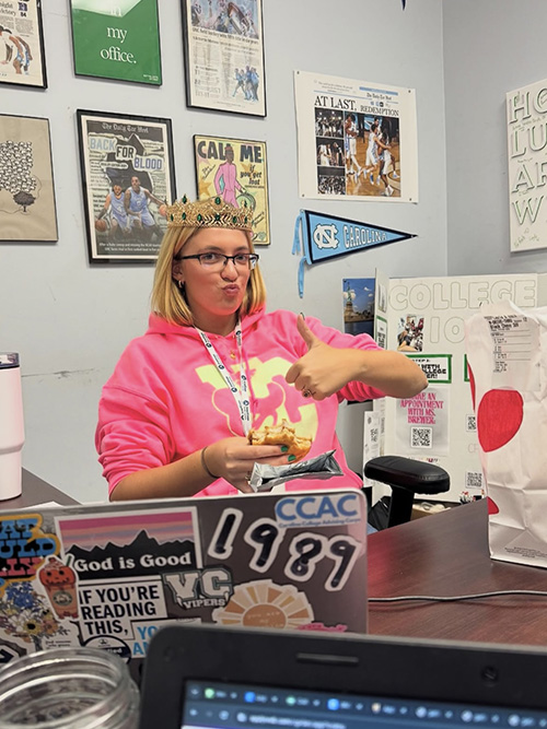 Layla Brewer sitting at her desk wearing a fun crown