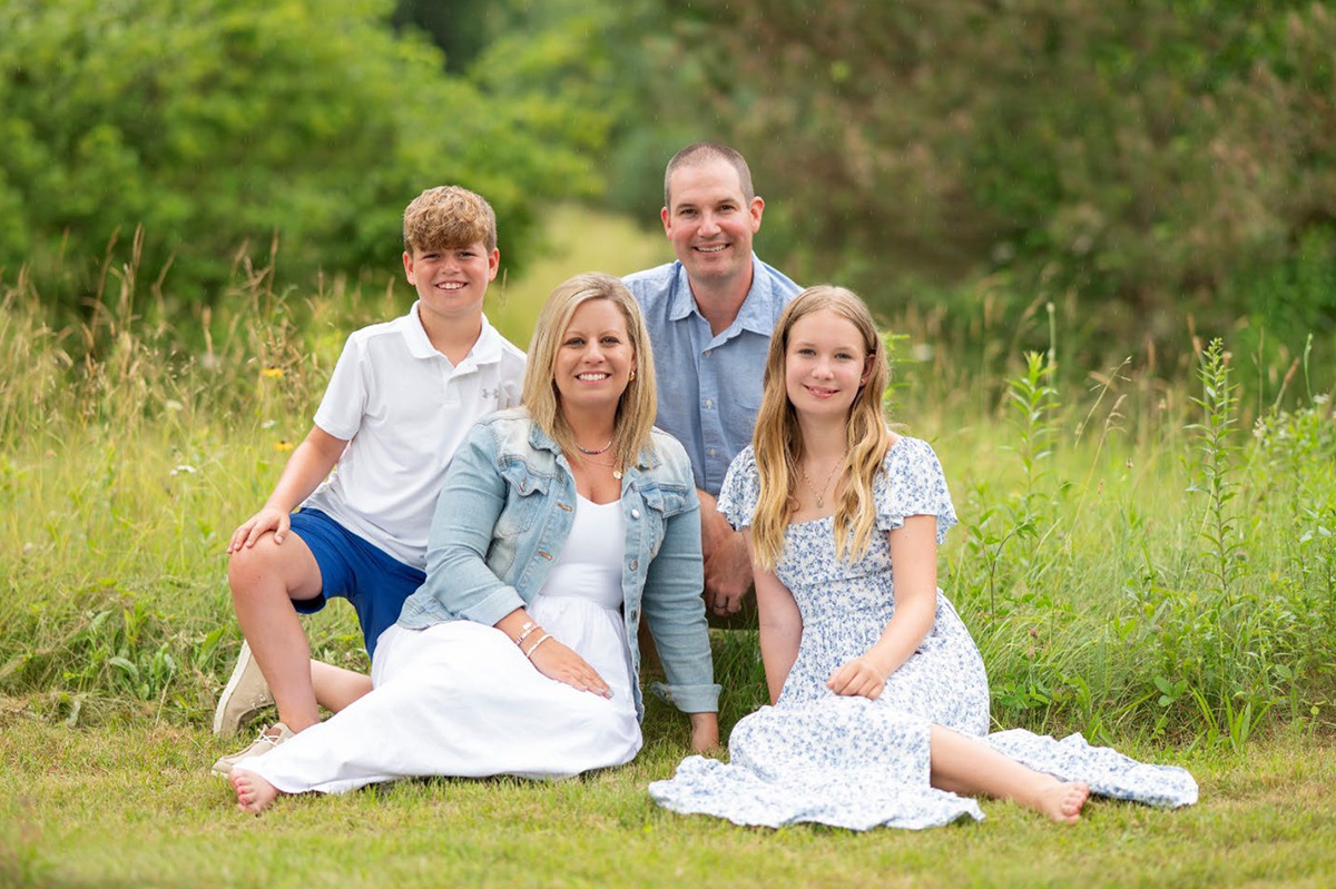 Kristie Byer, alumni of the month, with her family