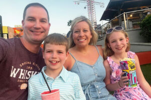 Kristie Byer, alumni of the month, with her family