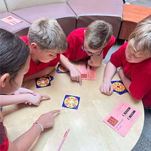 Students playing a game at a table