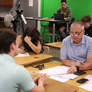 Teacher talking with a student in the classroom