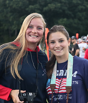 Two high school girls holding cameras