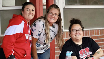 Three staff members outside