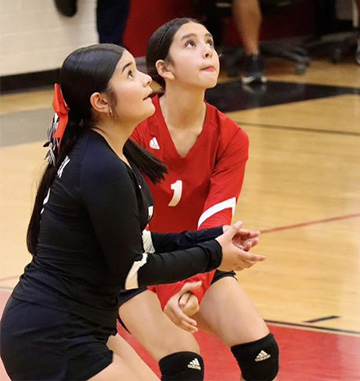 Two students ready to bump the volleyball
