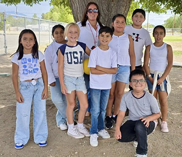 Teacher behind a group of students while outside