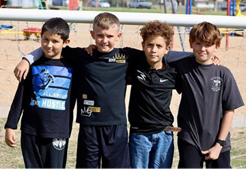 Students lined up outside with their arms around each other