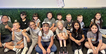 student group photo while sitting on the floor