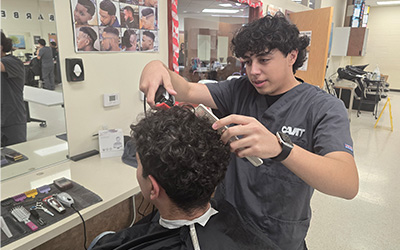 A student working on a person's hair