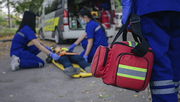 Emergency medical responders helping a injured person outside