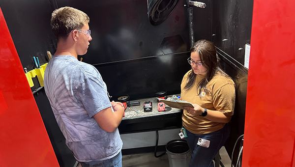 Student with woman visitor in a workshop space