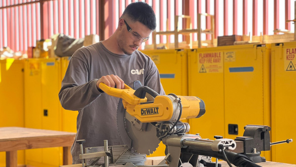 Student working with a saw