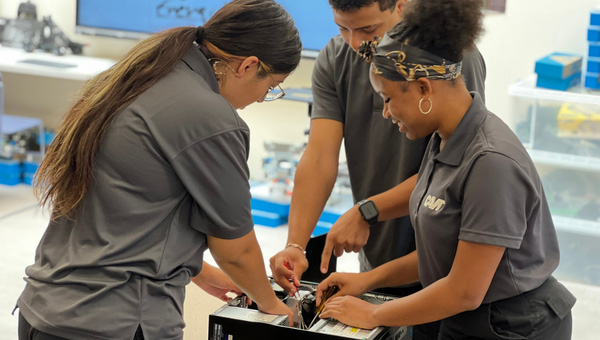 students taking a computer apart