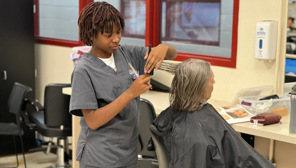Student cutting hair