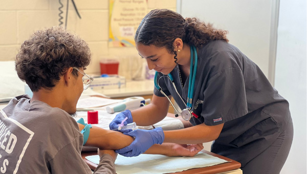A student drawing blood