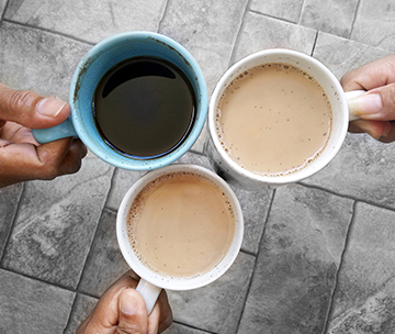 Three parents holding a cup of coffee