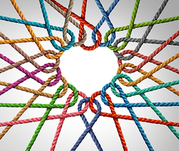 Colorful strings interlaced as a heart showing unity and partnership