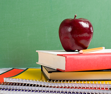 Red apple on top of books