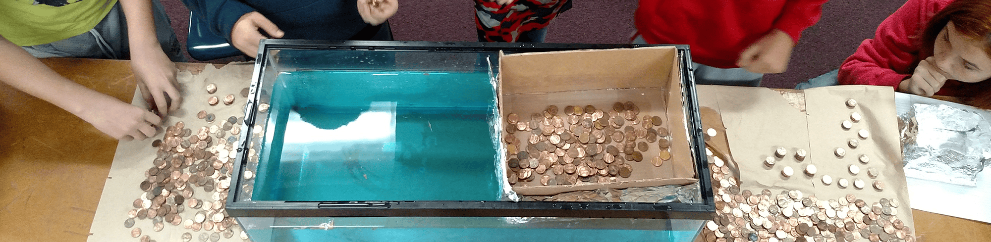 students working on an experiment with pennies
