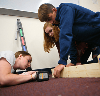 Three students working on a project