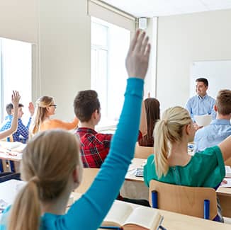 Students raising their hands in class