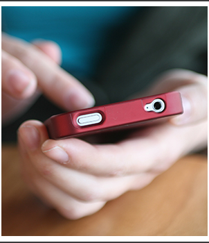 Hands holding a cell phone