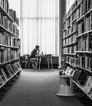 Student at a desk in a library