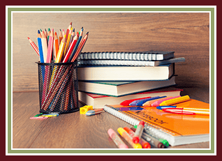 Schoolbooks and colored pencils sitting on a desk